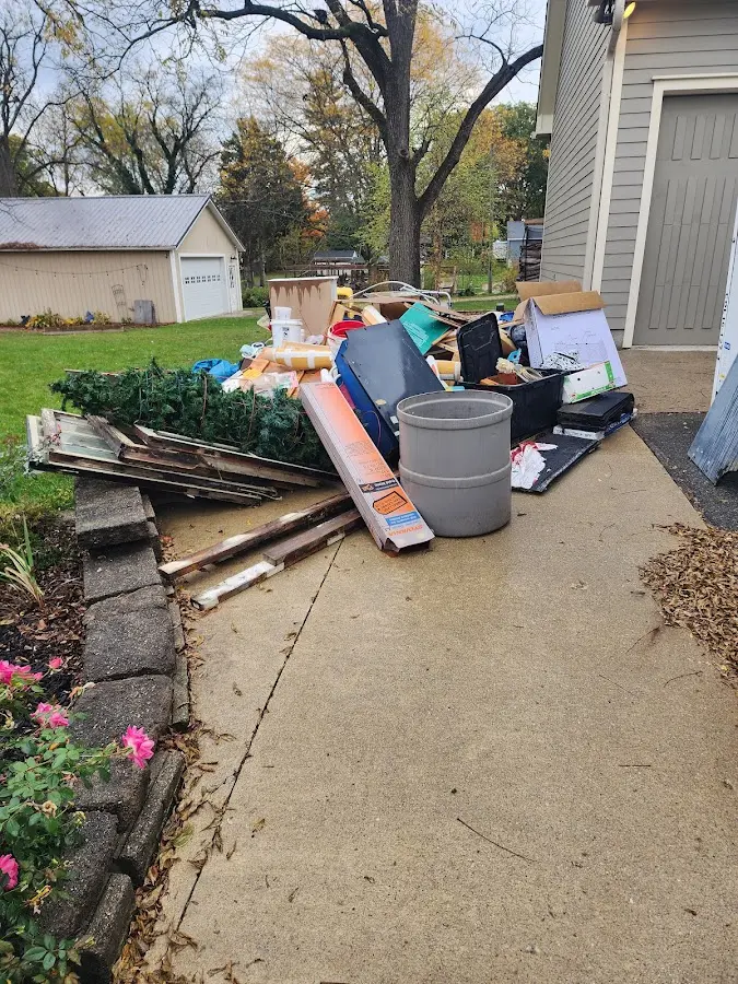Dumpster being loaded with debris for 12 Yard Dumpster Rental in Belchertown